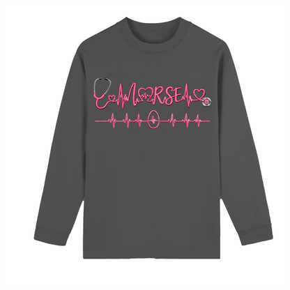 Not All Heroes Wear Capes long sleeve tee featuring a heartbeat design and stethoscope on a gray shirt.